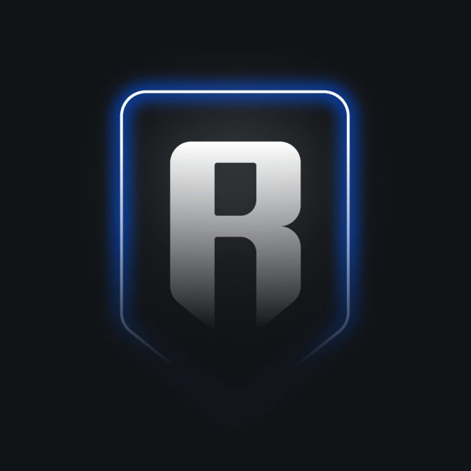 A stylized logo featuring a large metallic letter 'R' enclosed within a glowing blue shield outline against a black background.