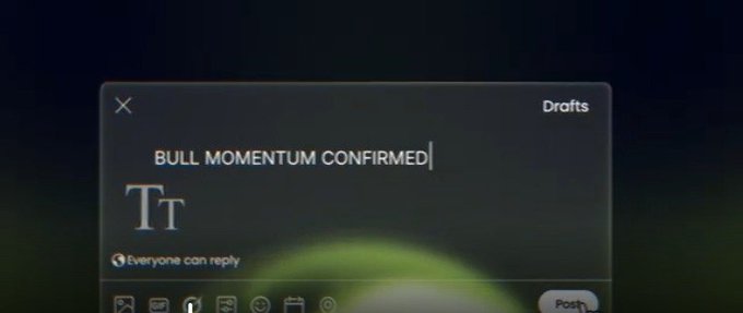 A dark-themed social media draft displays the bold headline "BULL MOMENTUM CONFIRMED" above a "Tt" text formatting icon, with an "Everyone can reply" indicator visible. The image complements the post by showing how traders compose and share crypto momentum signals on platforms like AlphaWire to broadcast market narratives before they gain mainstream attention.