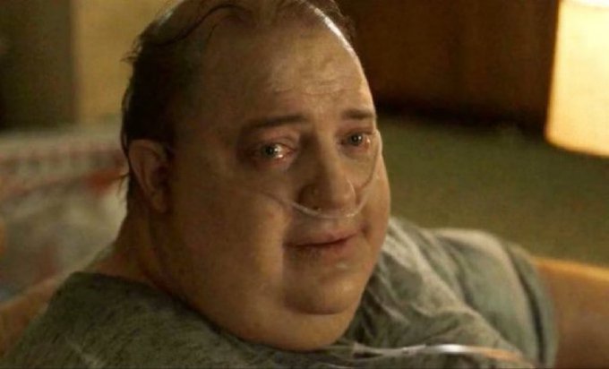 A close-up shot of a balding man with an oxygen tube in his nose, appearing emotional with tears in his eyes.