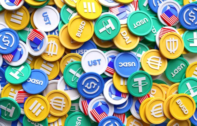 A colorful pile of cryptocurrency tokens including USDT, USDC, and BUSD symbols representing the global stablecoin market. The image visually reinforces the post's point about stablecoin price premiums in India, where USDT is now trading above its $1 peg due to regulatory crackdowns.