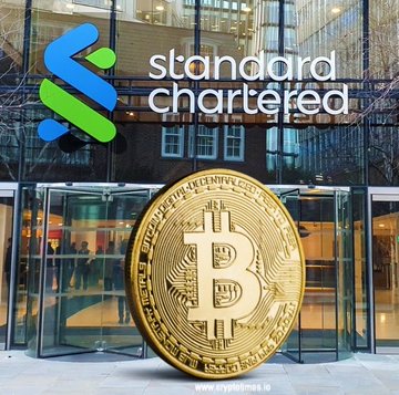 A large golden Bitcoin coin stands in front of the Standard Chartered bank building, with the bank's logo and name displayed on the glass facade, visually representing the financial institution's new spot crypto trading services for institutional clients in the UAE.
