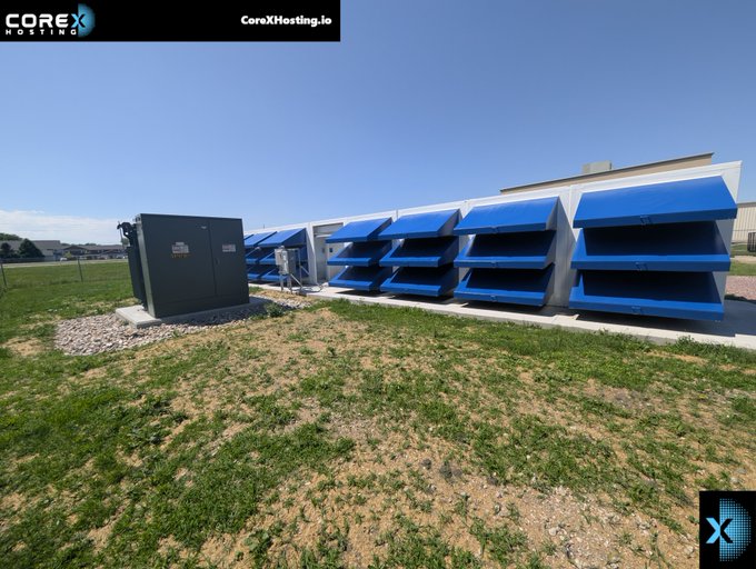 The image depicts an outdoor cryptocurrency mining facility featuring a row of large industrial fans with blue louvers alongside a transformer unit, with "CoreXHosting.io" branding visible in the top corner. The setup illustrates the cooling infrastructure needed for crypto mining operations, directly relating to the caption's mention of preparing the "Crypto Mining Shed" for upcoming filter maintenance and seasonal changes.