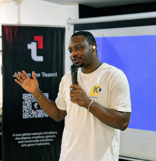 A man speaking into a microphone at a tech event with 'Avalanche' branding visible on a banner in the background.