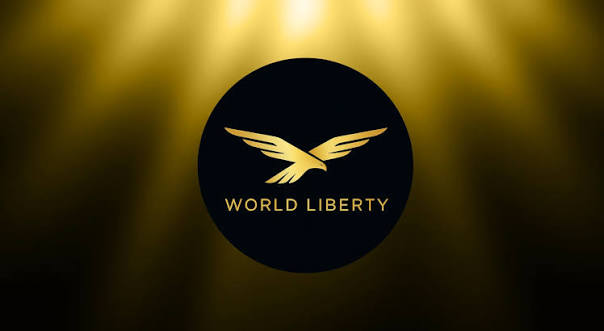 The image displays the "WORLD LIBERTY" logo featuring a golden eagle emblem on a dark circular badge, set against a dramatic golden spotlight background. This branding visually reinforces the post's announcement about World Liberty's new AI partnership with WorldClaw, which accepts $USD1 payments and brings together Trump-backed crypto, Chinese AI models, and stablecoin technology.
