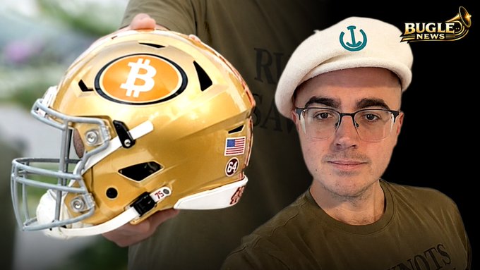 A man wearing glasses and a white Bitcoin-branded cap holds a gold football helmet featuring a Bitcoin logo and the number 64, in an image branded with "BUGLE NEWS" — visually amplifying a story about a scammer impersonating the "CEO of Bitcoin" to defraud investors of $1.3 million.