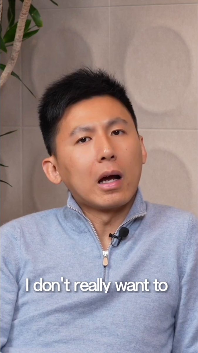 The image shows a man wearing a blue sweater, with his face partially visible as he looks at someone or something off-camera. The caption of the image reads "I don't really want to", which seems to be a reference to the statement made by @Aptos about Asia not coming and eating crypto in 2026. This message is related to the post because it highlights the idea that Asian economies are already locked out of the traditional global financial system, as they explore alternative means of currency and economic growth.