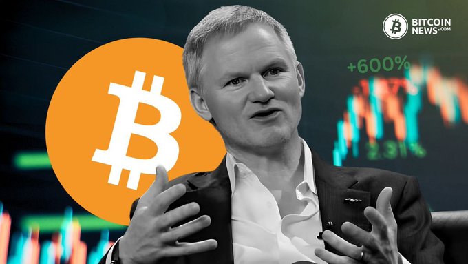 The image shows a man in a suit gesturing with his hands in front of a Bitcoin logo and trading chart showing "+600%" gains, with a "BitcoinNews.com" watermark, likely representing a Bitcoin industry executive commenting on the BitGo acquisition of NYDIG's institutional trading business.