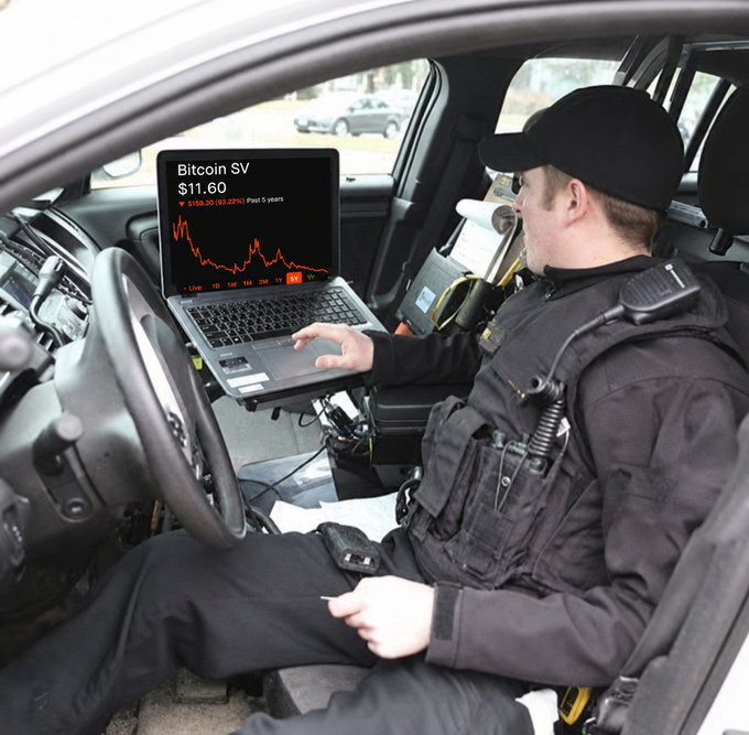 A man wearing a police uniform sits in his car, using his laptop as an unconventional desk, likely checking the price of Bitcoin for some financial context related to his work or personal interests. This scene highlights the fusion of modern technology with traditional professions like law enforcement.