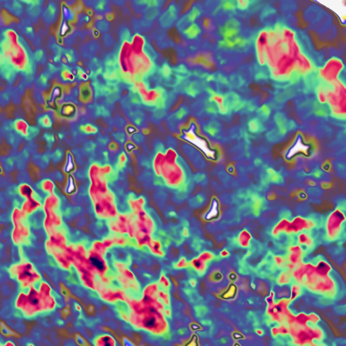 A vibrant, saturated image with colorful blotches of blue, pink, green, and yellow that resembles a thermal map or false-color scientific visualization.