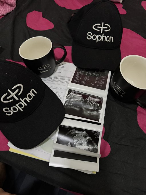 The image features a black hat with white text that says "Sophon" written on it, along with two cups of coffee placed next to each other. There are also some papers and photos related to the hat and its contents, such as an ultrasound picture or a list of items. The post appears to be about celebrating Father's Day, possibly suggesting that these items were purchased for someone who is expecting a child or has recently given birth.

The presence of the cups of coffee might indicate that the person receiving them is expecting a baby and wants to celebrate with their loved ones. The paper and photos could serve as keepsakes or reminders of the special occasion, while the ultrasound picture may be related to the expectant mother's pregnancy journey. Overall, the image conveys a sense of celebration and support for expectant parents during this important time in their lives.