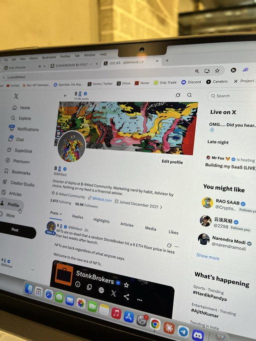 A photo of a MacBook screen displaying the X profile of @88tedd, Director at Alpha at B-Rated Community, featuring colorful NFT artwork and information about StonkBrokers.