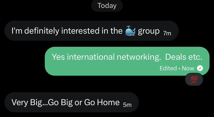 A dark-themed chat conversation displays a message exchange about a group interest involving international networking and deals, followed by a reply stating "Very Big…Go Big or Go Home," with a 🔥💯 emoji reaction visible next to the edited message.