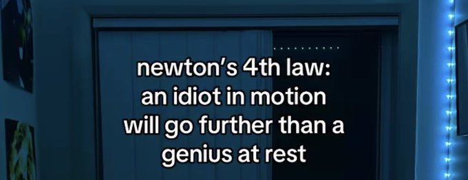 The image shows a dark blue room with a closed sliding door, framed by LED strip lights and some wall art on the left side. Overlaid text reads: quotes: style: "newton's 4th law: an idiot in motion will go further than a genius at rest" The joke perfectly complements the morning motivational post momentum and forward progress are the themes, reinforcing the idea that simply taking action (even without a perfect plan) leads to better results than overanalyzing and staying still, fitting the "WAGMI" (We're All Gonna Make It) and "we go again today" sentiment of pushing forward together.