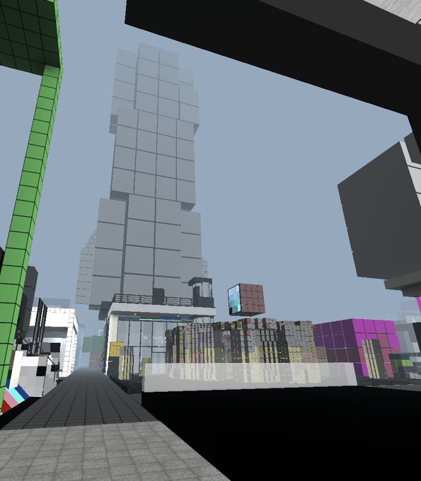 A Minecraft-style rendering showing a blocky cityscape with tall skyscrapers and a street view under a clear sky.