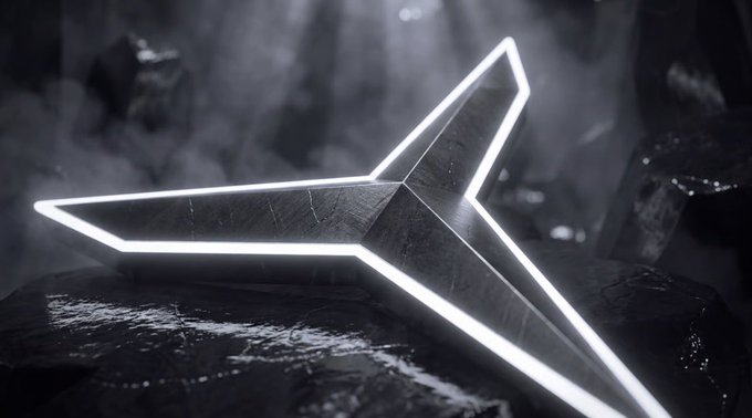 A metallic star-shaped object with glowing white edges resting on a wet rock surface in a dark, moody environment with mist.