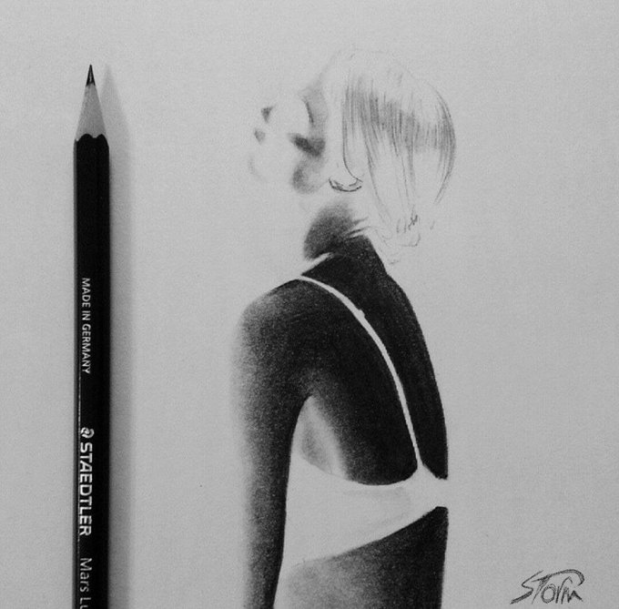 A pencil sketch artwork of a person in profile view wearing a sleeveless top, drawn with a Staedtler Mars Lumograph 'Made in Germany' pencil visible on the left side, signed 'STOFK'.