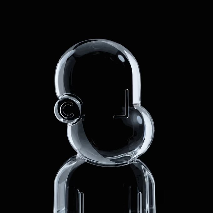 The image features a clear glass sculpture of an anthropomorphic face, which appears to be made from a material like plastic or glass. The sculpture has a unique design with two eyes and a mouth, giving it a human-like appearance. It is placed on a black surface against a white background, making the sculpture stand out prominently. The image also includes text that reads "NPC #9007 just sold for 1.99 ETH." This suggests that the sculpture might be a collectible item or an art piece with significant value in the market.