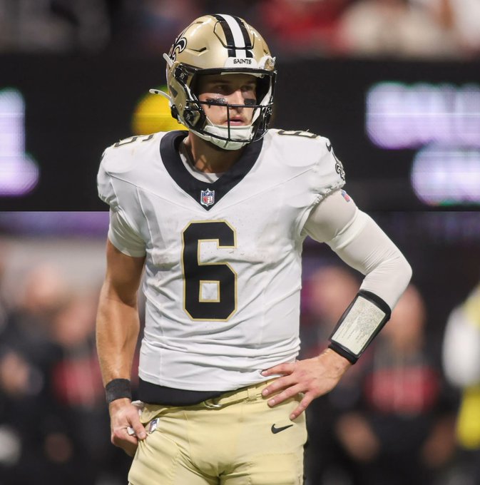 New Orleans Saints quarterback wearing jersey number 6 and a gold helmet stands on the field during an NFL game.