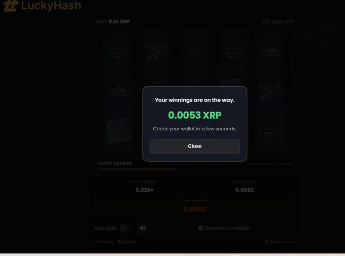 A LuckyHash slot game win notification showing '0.0053 XRP' winnings on the way, with a spin cost of 0.01 XRP and an empty Lucky Charge bar.