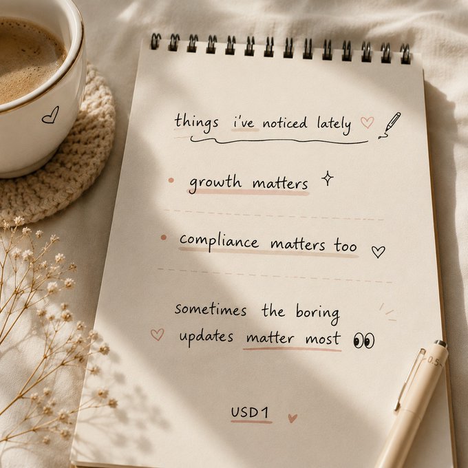 The image features a notebook with a pen on top of it, along with a cup of coffee nearby. The notebook contains a list of things to do, which includes updating compliance matters, growth matters, and other tasks related to trading pairs or ecosystem growth. The focus is on compliance, as indicated by the post's title "Most discussions around $USD1 lately have been about new integrations, trading pairs, and ecosystem growth".