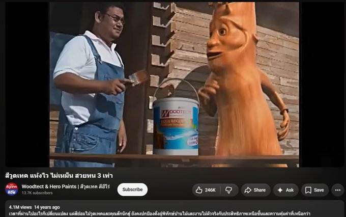 A YouTube thumbnail from "Woodtect & Hero Paints" channel shows a man in blue overalls holding a paint can and brush next to a whimsical clay tree-creature mascot, with 13.7K subscribers and 4.1M views displayed. The Thai text and old commercial aesthetic support the post's reference to "KhunSak" being a long-running, nostalgic brand (14 years old) similar to $TRIPLET, emphasizing its authentic, vintage origin rather than a newly created trend.