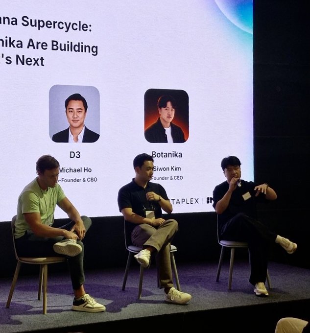 Three men sit on stools on a stage participating in a panel discussion titled 'Korea Supercycle: Botanika Are Building Asia's Next,' with D3 (Michael Ho) and Botanika (Giwon Kim) shown on the screen behind them.