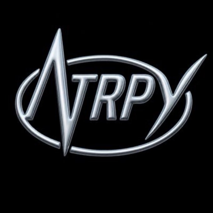 A metallic silver logo for 'TRPY' cryptocurrency set against a black background, with the letters enclosed in an oval shape.