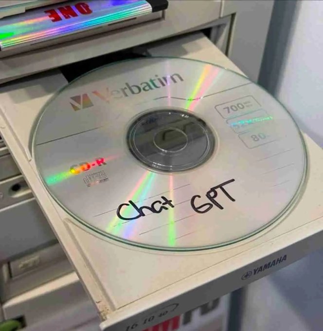 A Verbatim CD-R disc labeled 'Chat GPT' in handwritten marker sits on the open tray of a Yamaha CD burner, with a colorful rainbow prism reflection visible on the disc's surface.