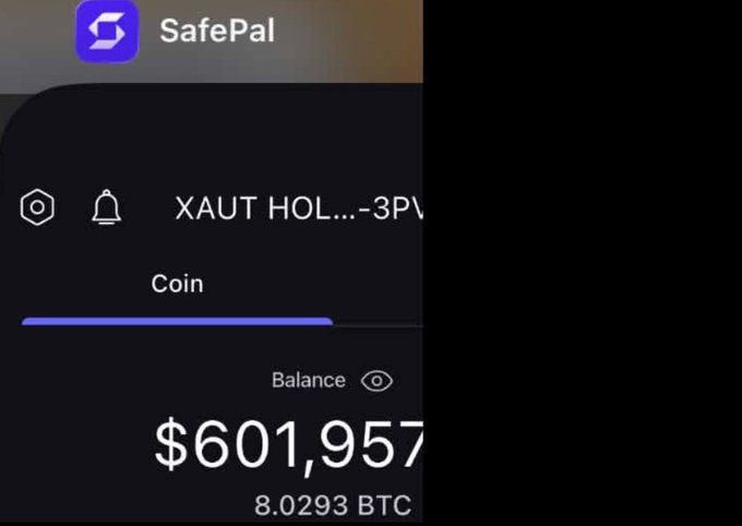 A SafePal cryptocurrency wallet app displays a balance of $601,957 (8.0293 BTC) for a 'XAUT HOL...-3P' coin/token.