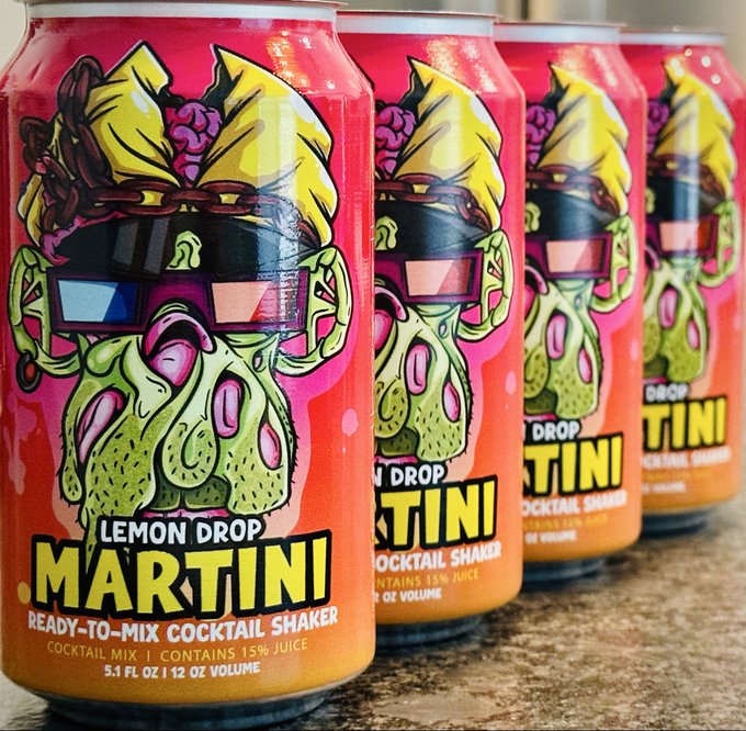 A row of brightly colored "LEMON DROP MARTINI" ready-to-mix cocktail shaker cans (5.1 FL OZ / 12 OZ VOLUME) featuring a vibrant, psychedelic illustration of an octopus-like character with 3D glasses and a bow.