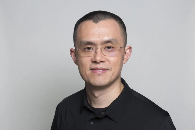 A professional headshot of a man with short black hair and rimless glasses, wearing a black collared shirt against a plain light gray background. The image likely depicts Changpeng Zhao (CZ), the founder of Binance, in connection with his recent public comments criticizing MicroStrategy's Michael Saylor's $STRC as "overengineered and too complex."