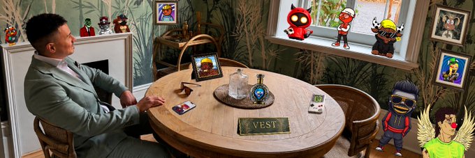 A stylized photo-style composition showing a man in a green suit sitting at a round wooden table labeled 'VEST,' with cartoon NFT characters and trading cards decorating the scene in a crypto/Web3 themed setting.