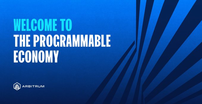The image features a blue banner with white text that reads "Welcome To The Programmable Economy" and "Finance Is Becoming Programmable. For Enterprises, That Means Faster Workflows, Predictable Settlement And Markets That Adapt In Real Time". The image also includes an arrow pointing to the bottom right corner of the banner.