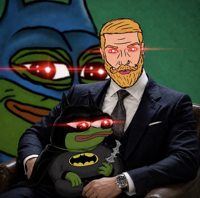 An edited image featuring a suited man and a Batman-costumed Pepe the Frog with glowing red eyes, set against a dark green background with a larger Pepe image.
