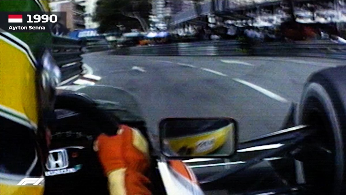 Onboard footage from 1990 showing Formula 1 driver Ayrton Senna racing through the streets of Monaco, with his name and the year displayed in the top left corner.