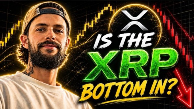 A bearded man in a backwards cap appears alongside bold text reading "IS THE XRP BOTTOM IN?" and the X (formerly Twitter) logo, set against a candlestick chart with downward-trending red arrows. The image serves as a YouTube thumbnail asking whether XRP has hit its price low, tying into the post's link to full XRP coverage.
