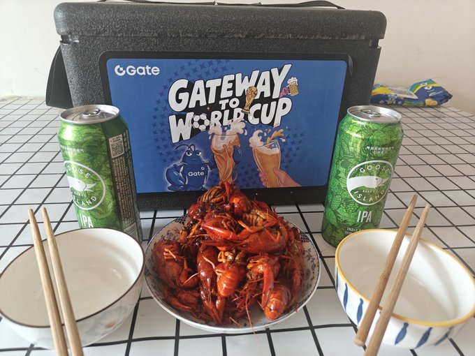 Promotional photo for 'Gate to World Cup' featuring a Gate cooler bag, two Goose Island IPA cans, and a bowl of spicy crawfish with chopsticks and bowls on a grid tablecloth.