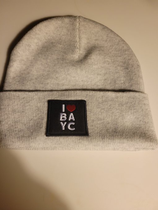 A gray cuffed beanie with a black patch reading 'I ❤ BAYC' (I love BAYC/Ape Yacht Club) in white lettering.