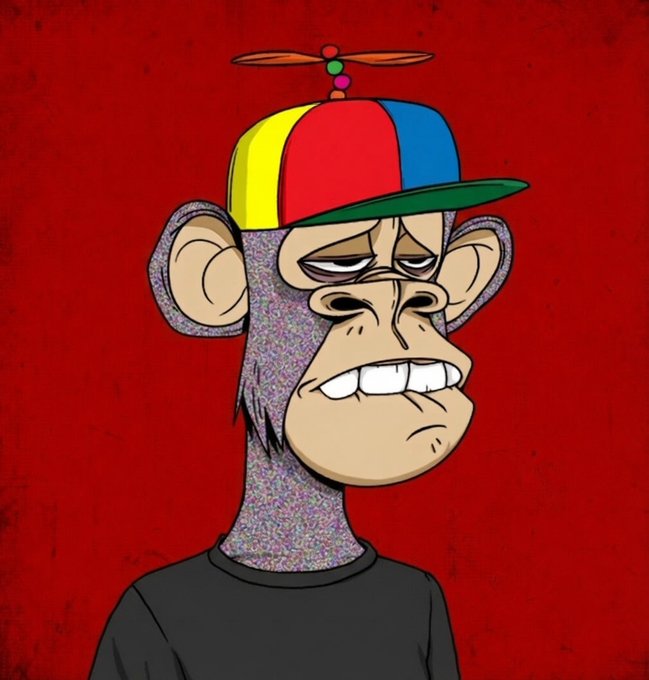 The image features a cartoon monkey wearing a colorful hat with a propeller on top of it. The monkey appears to be frowning or looking sad while standing against a red background. There are no other objects or text present in the image, making the focus solely on the monkey and its surroundings. The post suggests that this new BAYC background would suit the cartoon character well, as it complements the colorful hat and adds an interesting visual element to the overall composition of the image.