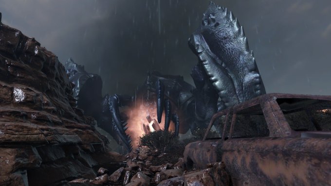 A cinematic scene shows a giant mechanical creature emerging from rubble between rusted car wrecks in a dark, rainy environment with sparks flying.