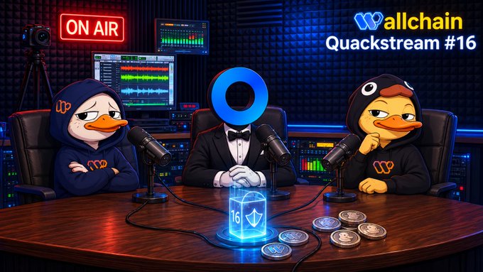 The image features a cartoon duck sitting at a table with three other cartoon ducks, all dressed up in suits and ties. The cartoon ducks are seated around a microphone, suggesting that they might be participating in an interview or a podcast recording session. The background of the image is dark blue, which contrasts with the light brown color of the wooden table where the ducks are sitting. The text "Wallchain Quackstream 16" can also be seen on the image.