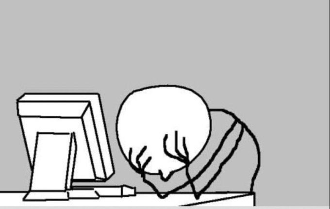 A minimalist line drawing of a bald figure with their head in their hands, sitting in front of a computer monitor against a gray background, conveying frustration or exhaustion.
