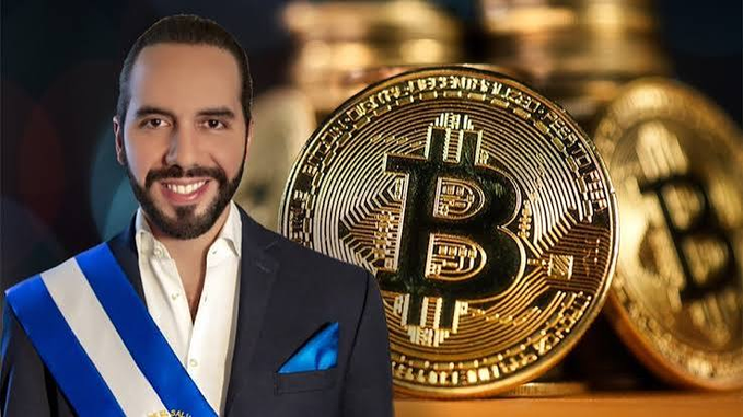 A smiling man with a beard wearing a presidential sash with blue and white colors (Nayib Bukele of El Salvador), standing in front of a backdrop of large golden Bitcoin coins.