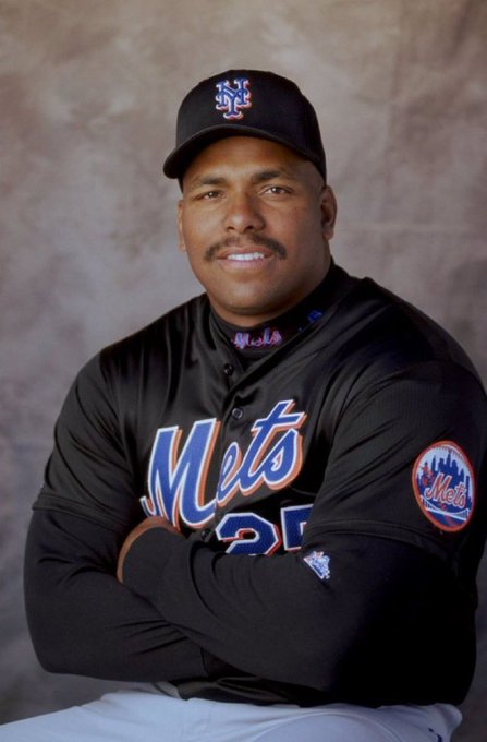 A professional baseball portrait of a New York Mets player wearing a black cap with the 'NY' logo and a black Mets jersey with the team patch on the sleeve.