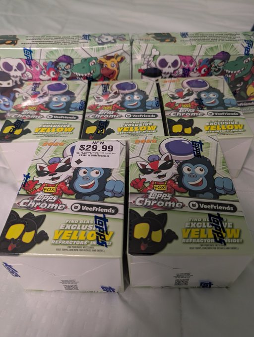 The image shows a collection of seven trading cards, each with a different cartoon character on them. The cards are neatly arranged in four rows, making for an orderly display. The top row features three cards from the Chrome series, while the bottom two rows contain one card from each series – yellow and blue. The cards are white, standing out against the dark background of the image, adding a pop of color to the scene.