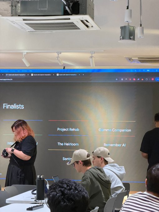 A person stands before a large screen displaying the "Finalists" list at the Gemini Hackathon Singapore, with "Familiar" visible among the entries like "Project Rehab," "Gamma Companion," "The Heirloom," and "Remember AI," while other attendees sit nearby. The image captures the moment of recognition as the poster celebrates their project, which transforms Telegram into a private family memory platform, advancing to the finals.