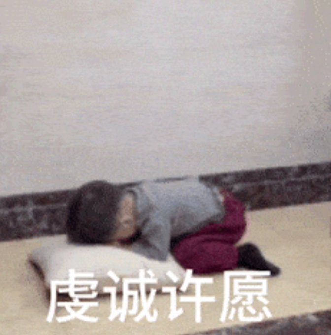 A person lying face down on a pillow on the floor, with Chinese text '虔诚许愿' (sincere wish) displayed at the bottom.