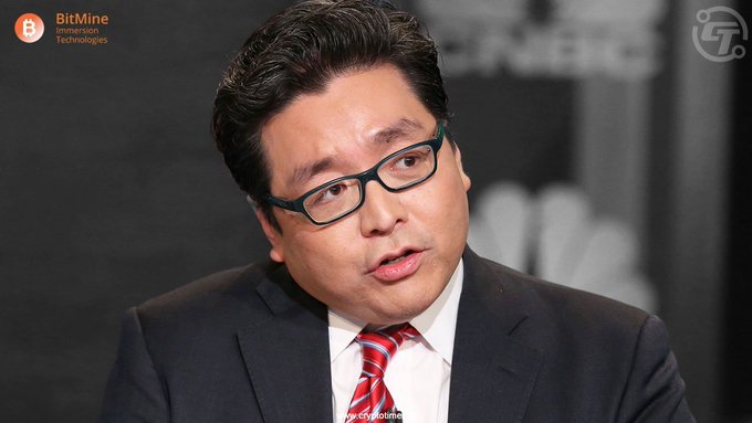 A suited man with glasses and a red striped tie appears on screen, with a "BitMine Immersion Technologies" logo in the upper left, in an interview setting accompanying news that Tom Lee's BitMine purchased 10,399 ETH last week.