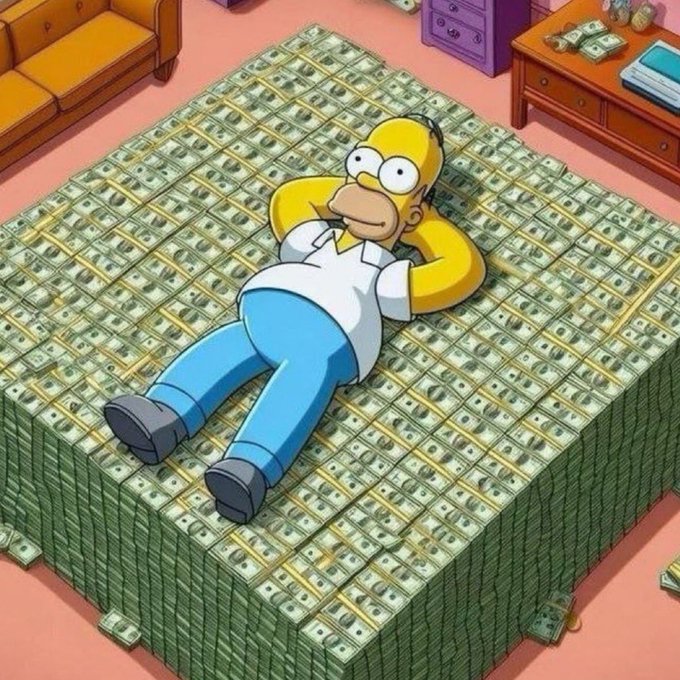 An image of Homer Simpson from The Simpsons lying on a giant bed made of stacks of money.