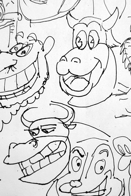 A black-and-white sketch featuring multiple cartoonish character faces, including what appears to be animals and expressive caricatures with exaggerated features.